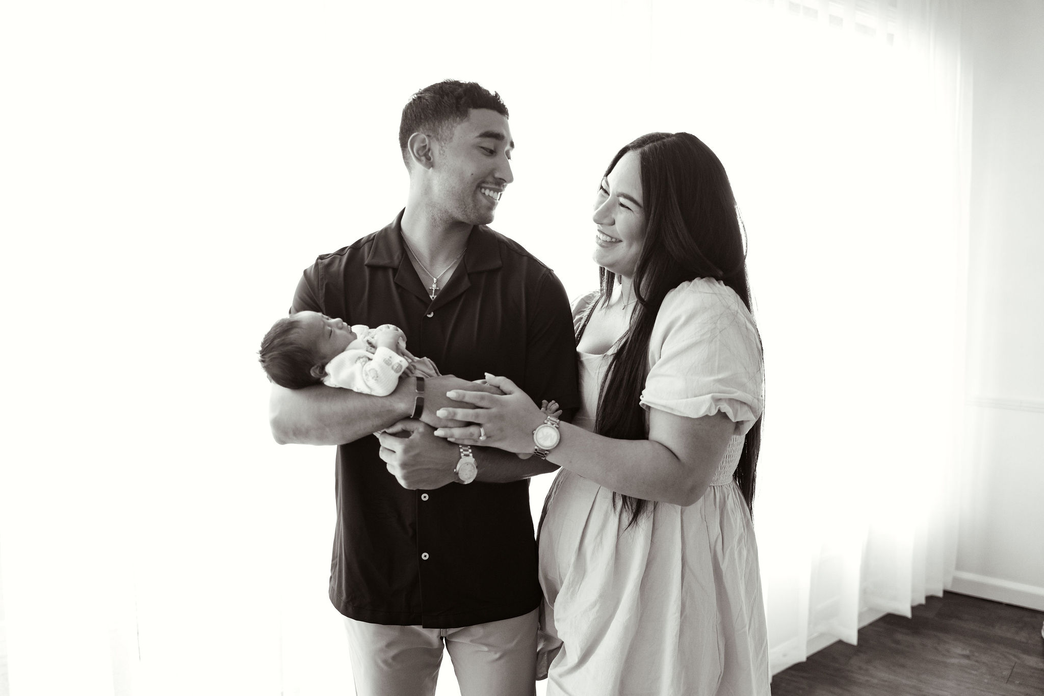 New parents with newborn baby during newborn photos in Dothan